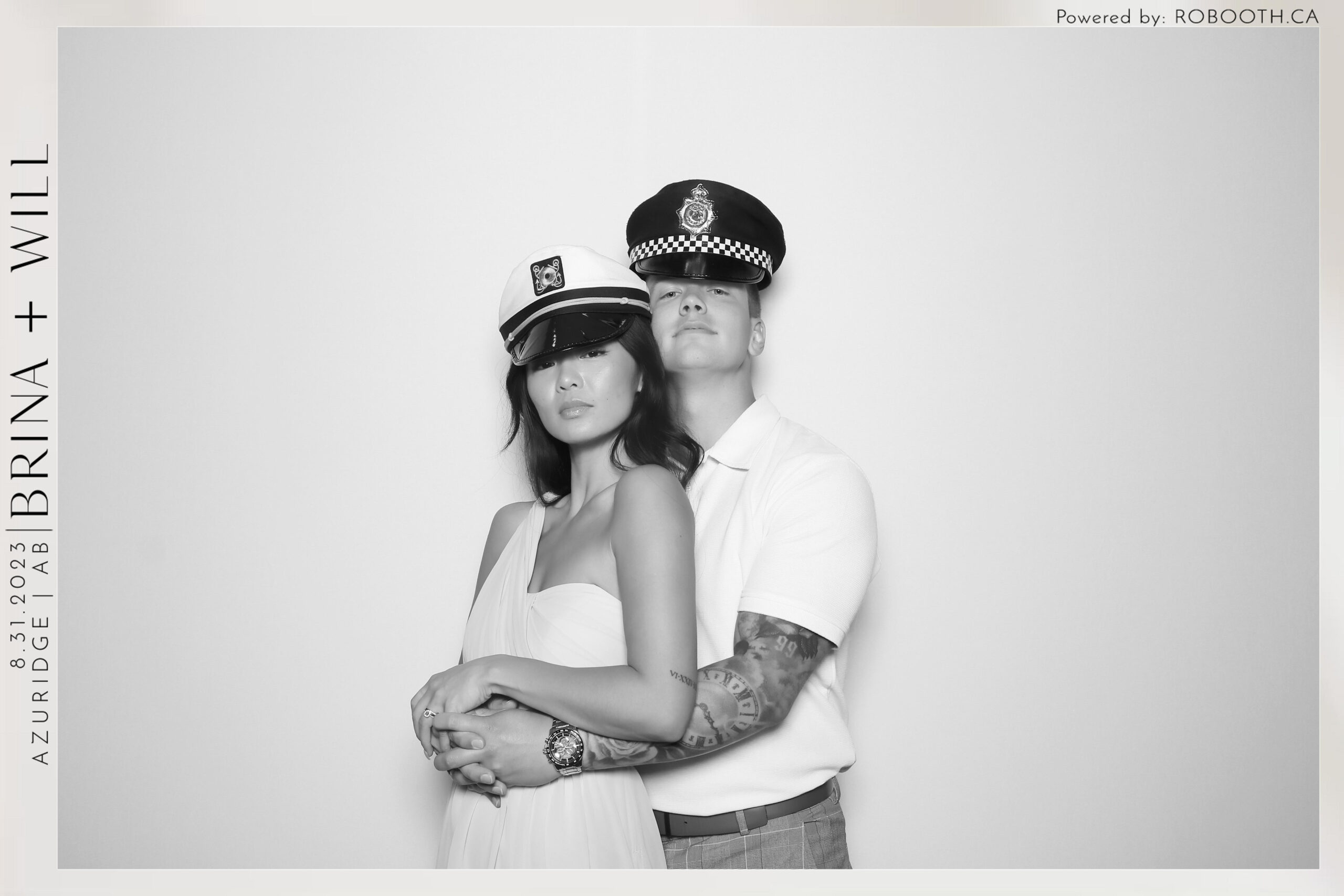 black and white photo of couple dressed as sailors in photo booth at wedding in Calgary ca