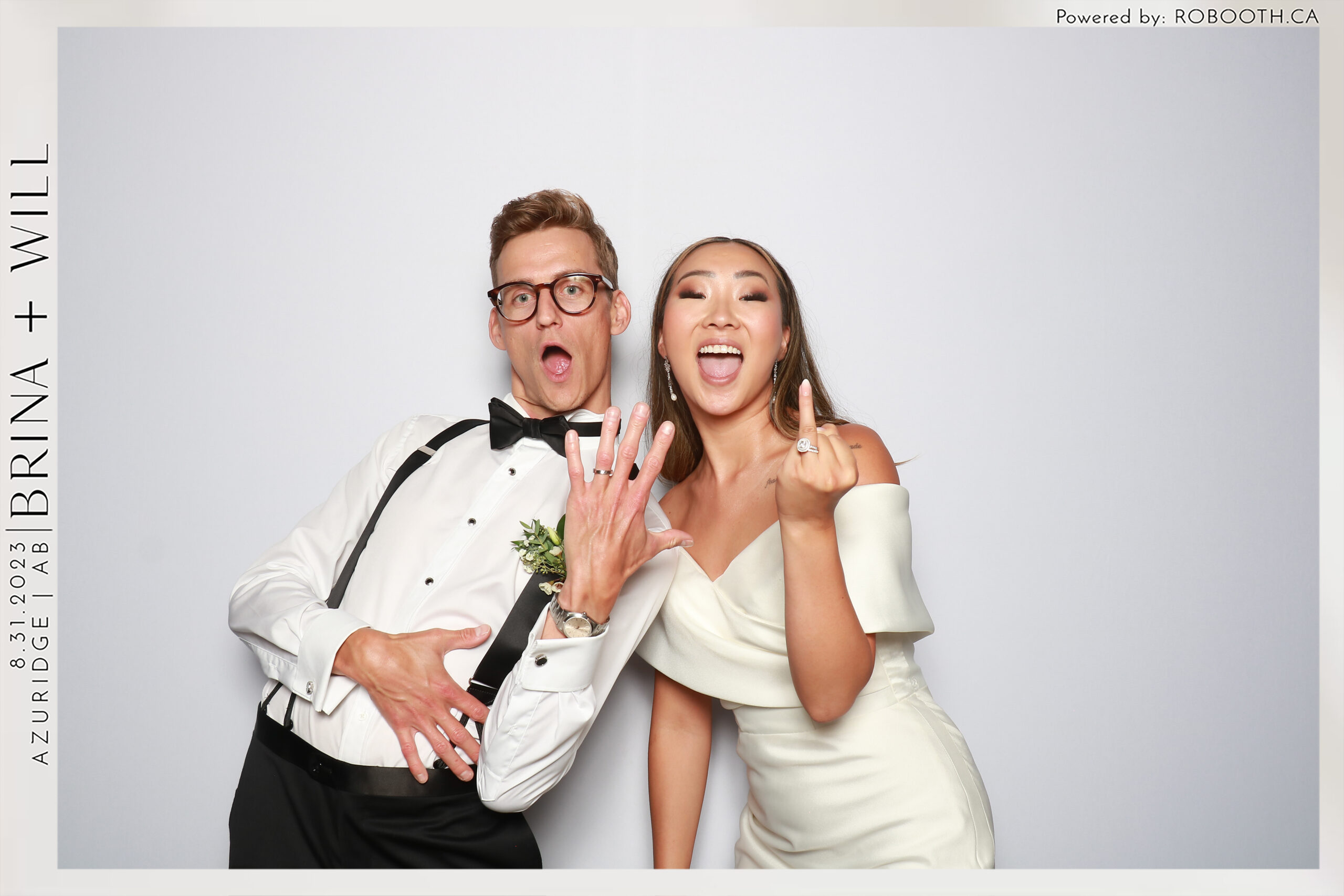 Black and white photo of couple having fun in the photo booth at a wedding in Calgary, CA - Robooth